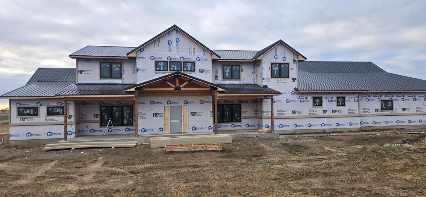 Two story custom home under construction with timber entry, Sioux Falls area