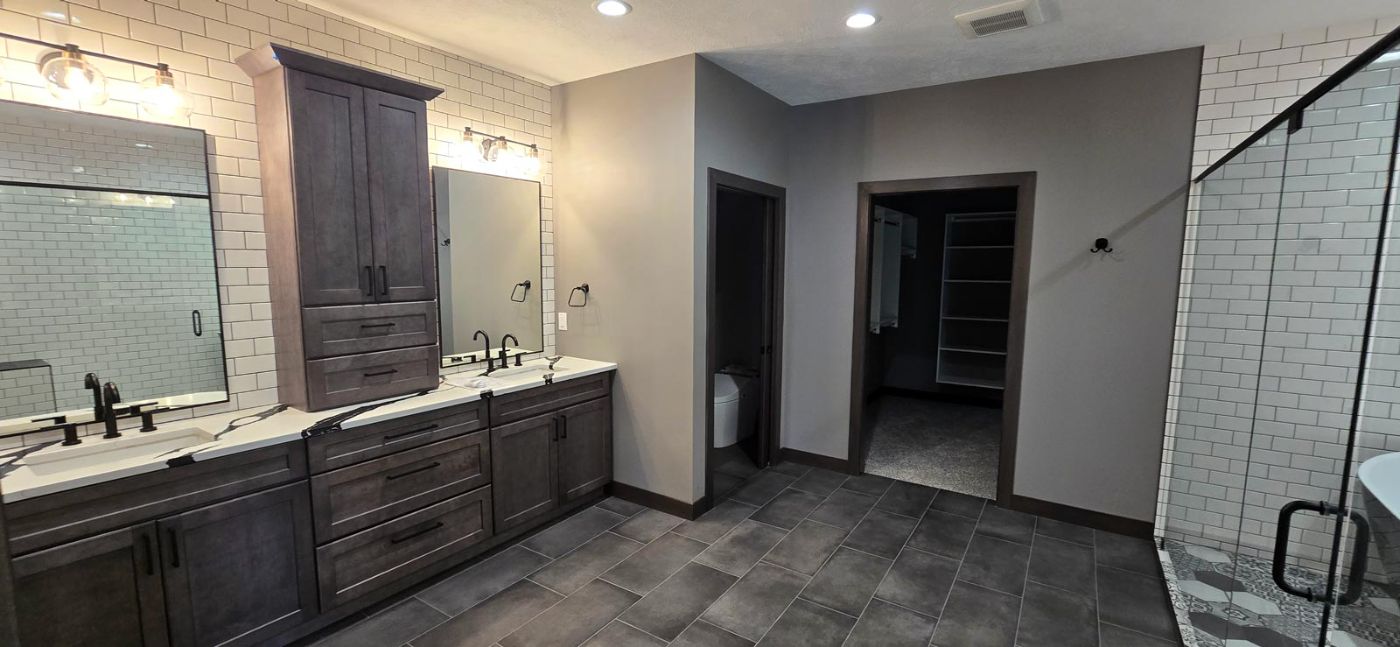 Wet room bath with subway tile, freestanding soaking tub and hexagon floor tile, custom home Tea, SD