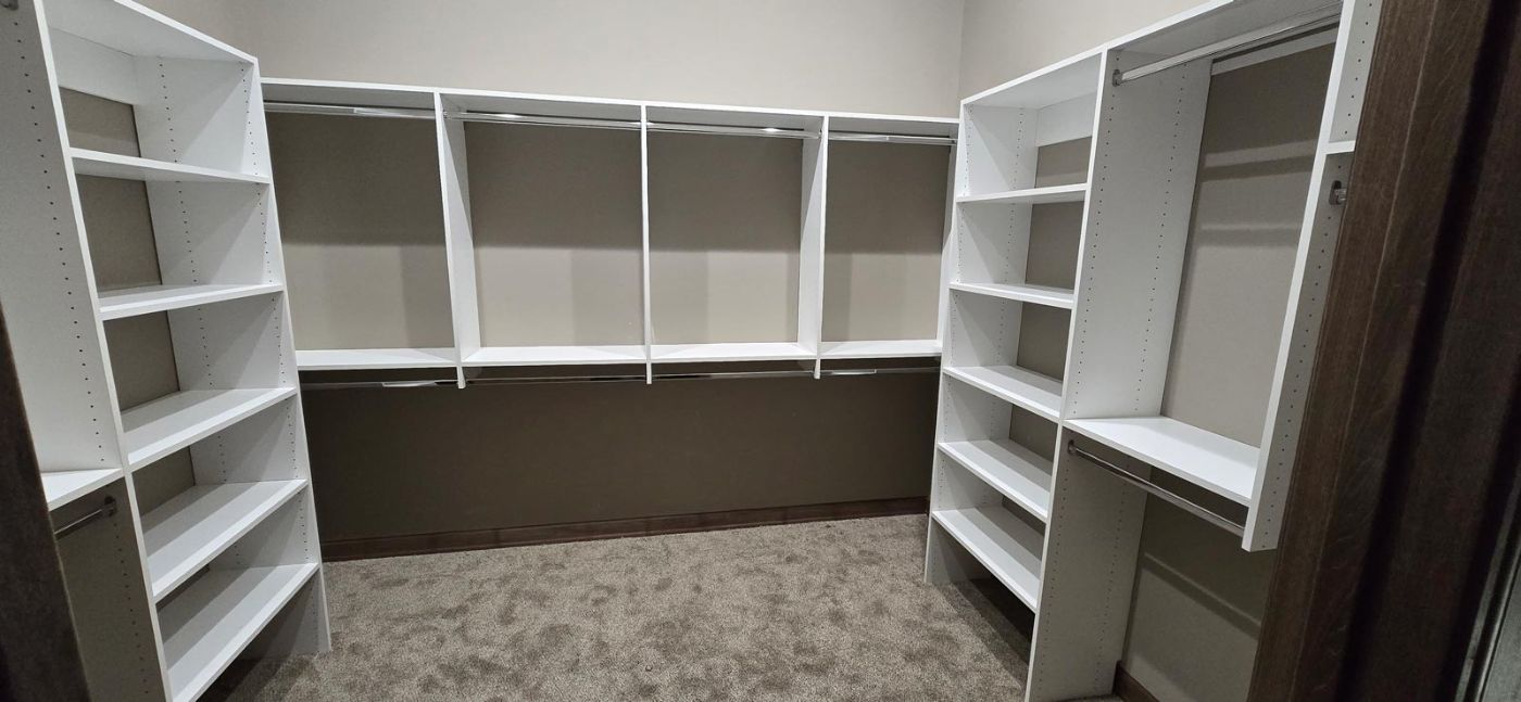 Custom built walk-in closet shelving in a South Dakota custom home