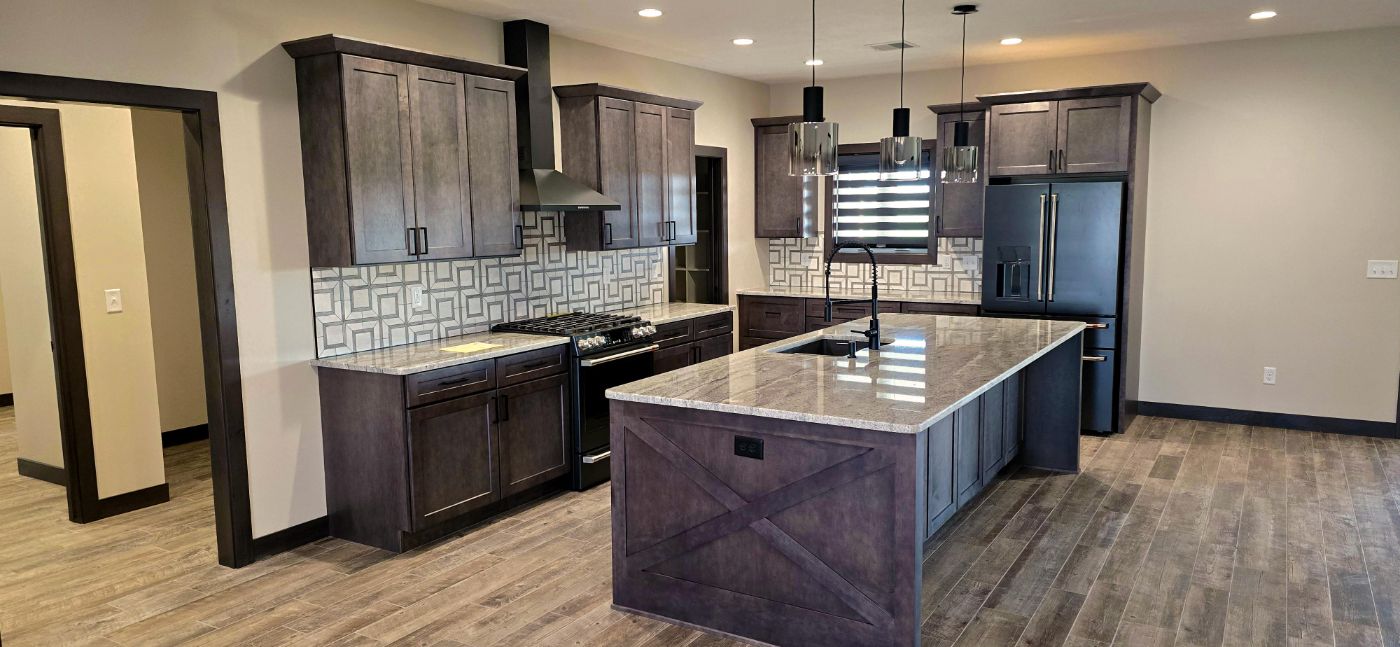 Custom kitchen with stainless appliances, tile backsplash and granite island, Hahn Custom Homes